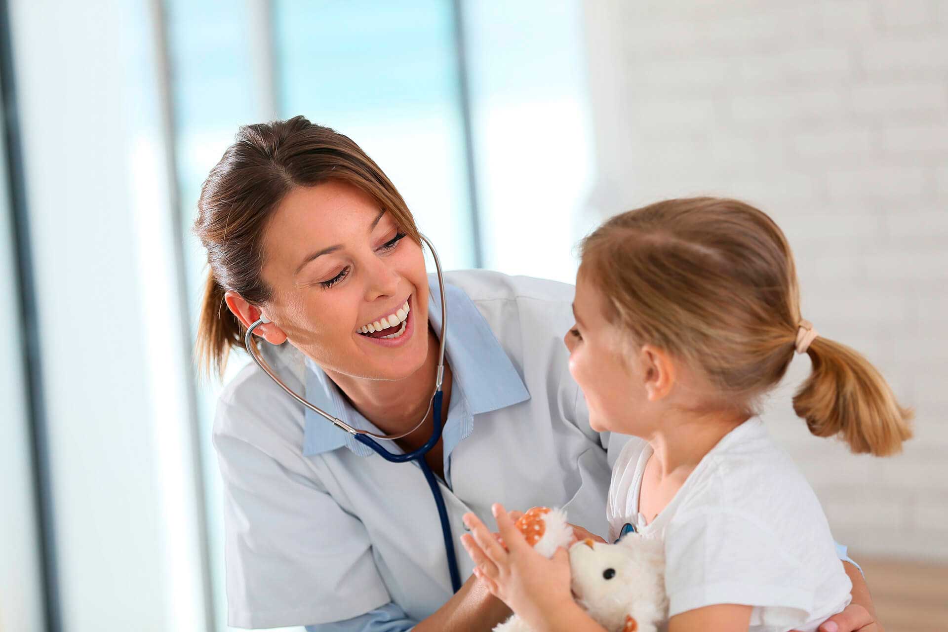 Woman doctor and girl smiling